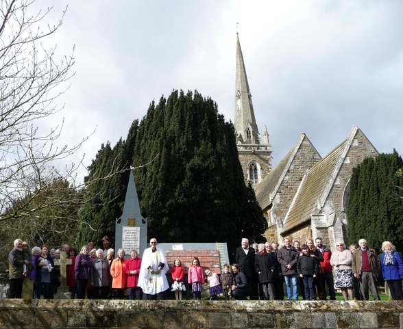 Members of the congregation outside All Saints Church, Newton on Ouse, near the appeal totaliser.