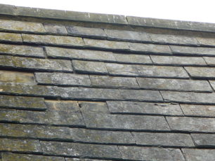 The old, warped and crumbling slates originally on the roofs.